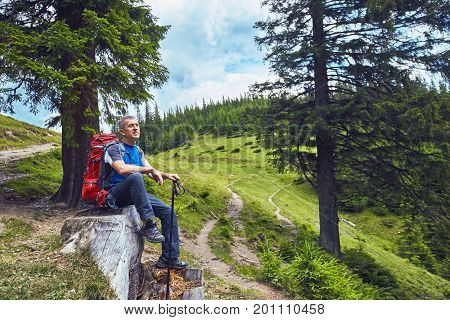 Hiking in the mountains with a backpack in the summer.