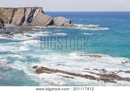 Wave And Cliffs In The Beach In Almograve