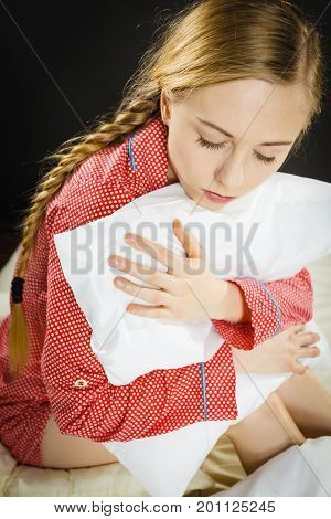 Sad Depressed Girl In Bed Gripping Pillow