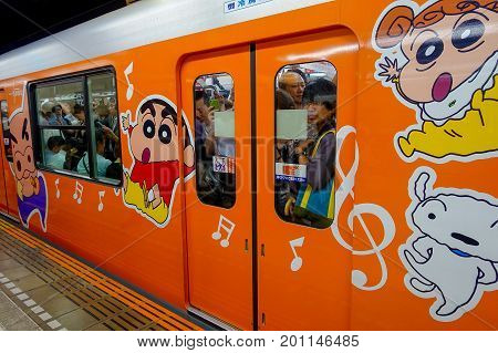 TOKYO, JAPAN - CIRCA MAY 2014: Crowd of passengers inside of train at Ikebukuro station in Tokyo, Japan. Ikebukuru is the second-busiest railway station in the world.