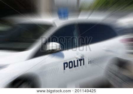 Police car with lettering and blue light. Denmark.