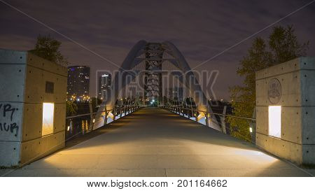 Humber Bay Arch Bridge with downtown Toronto seen in distance.