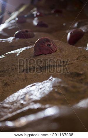 Close-up of wall with footholds in fitness studio