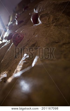 Close-up of wall with footholds in fitness studio