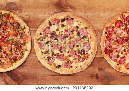Pizza on wooden table top view. Fast food Delicious. Post blog social media. View from above with copy space. Banner template layout mockup top view on pizza. Pizza ready to eat.