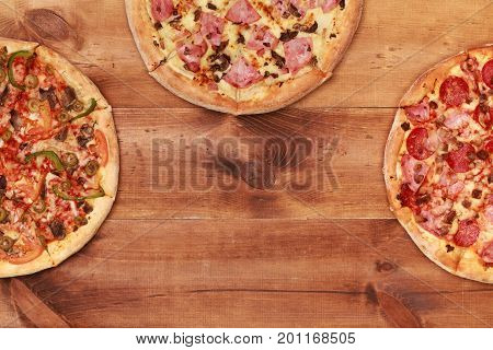 Pizza on wooden table top view. Fast food Delicious. Post blog social media. View from above with copy space. Banner template layout mockup top view on pizza. Pizza ready to eat.