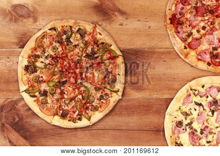 Pizza on wooden table top view. Fast food Delicious. Post blog social media. View from above with copy space. Banner template layout mockup top view on pizza. Pizza ready to eat.