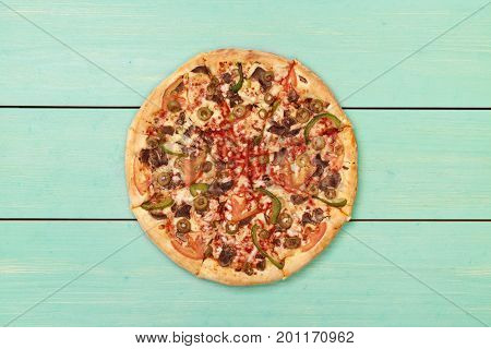 Pizza on wooden. Wooden table top view. On the table are the food for cooking. Healthy food. Dietetic foods. Above view on food. Hot Homemade Pepperoni Pizza Ready to Eat