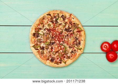 Pizza on wooden. Wooden table top view. On the table are the food for cooking. Healthy food. Dietetic foods. Above view on food. Hot Homemade Pepperoni Pizza Ready to Eat