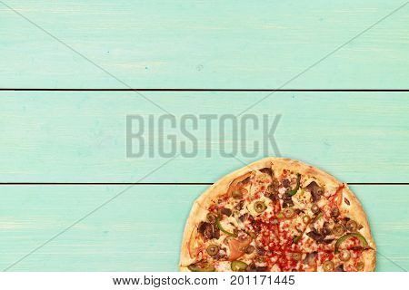 Pizza on wooden. Wooden table top view. On the table are the food for cooking. Healthy food. Dietetic foods. Above view on food. Hot Homemade Pepperoni Pizza Ready to Eat