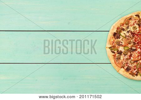 Pizza on wooden. Wooden table top view. On the table are the food for cooking. Healthy food. Dietetic foods. Above view on food. Hot Homemade Pepperoni Pizza Ready to Eat