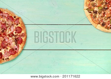 Pizza on wooden. Wooden table top view. On the table are the food for cooking. Healthy food. Dietetic foods. Above view on food. Hot Homemade Pepperoni Pizza Ready to Eat