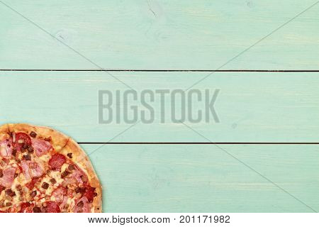Pizza on wooden. Wooden table top view. On the table are the food for cooking. Healthy food. Dietetic foods. Above view on food. Hot Homemade Pepperoni Pizza Ready to Eat