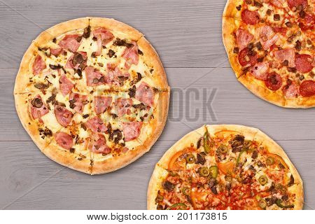 Pizza on wooden table top view. Fast food Delicious. Post blog social media. View from above with copy space. Banner template layout mockup top view on pizza. Pizza ready to eat.
