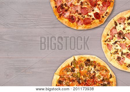 Pizza on wooden table top view. Fast food Delicious. Post blog social media. View from above with copy space. Banner template layout mockup top view on pizza. Pizza ready to eat.