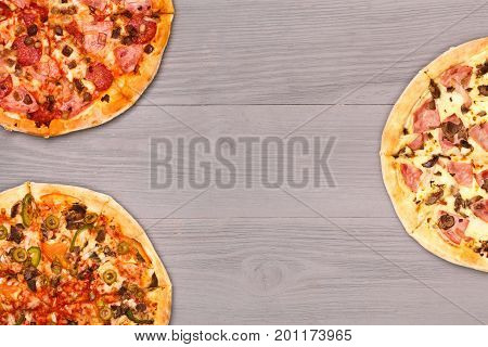 Pizza on wooden table top view. Fast food Delicious. Post blog social media. View from above with copy space. Banner template layout mockup top view on pizza. Pizza ready to eat.