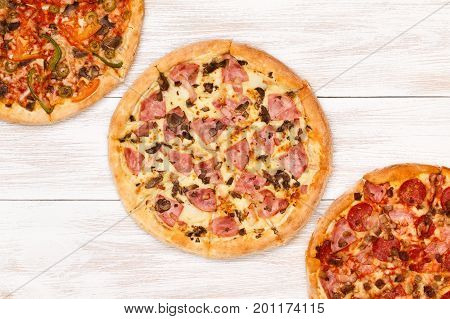 Pizza on wooden table top view. Fast food Delicious. Post blog social media. View from above with copy space. Banner template layout mockup top view on pizza. Pizza ready to eat.
