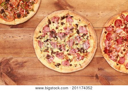Pizza on wooden table top view. Fast food Delicious. Post blog social media. View from above with copy space. Banner template layout mockup top view on pizza. Pizza ready to eat.