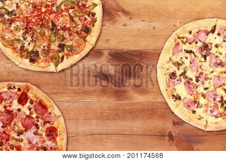 Pizza on wooden table top view. Fast food Delicious. Post blog social media. View from above with copy space. Banner template layout mockup top view on pizza. Pizza ready to eat.