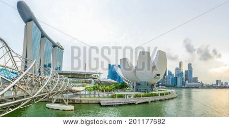 Singapore, Singapore - August 24, 2017: View at the Marina Bay in Singapore during the afternoon with the iconic landmarks of The Helix Bridge.
