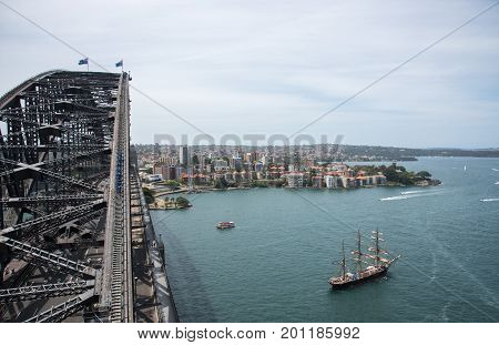 SYDNEY,NSW,AUSTRALIA-NOVEMBER 20,2016: Sydney Harbour Bridge arch with bridge climbers and tall ship in harbour in Sydney, Australia.