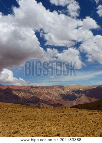 Mountain rainbow Standing in front of the colorful Serrania de Hornocal. This fascinating geology is a limestone formation with minerals being eroded stripped a symphony of colors on the mountainsides. Definitively one of the wonders of the north of Argen