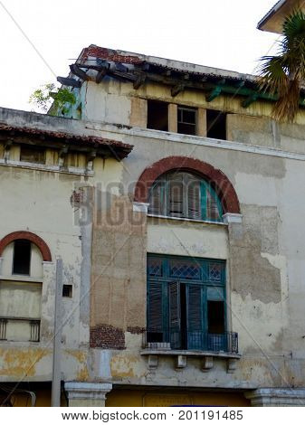 Weathered and colored windows and balcony terrace