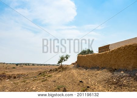 Horizontal picture of the wall of traditional houses in Thar Desert located close to Jaisalmer the Golden City in India.