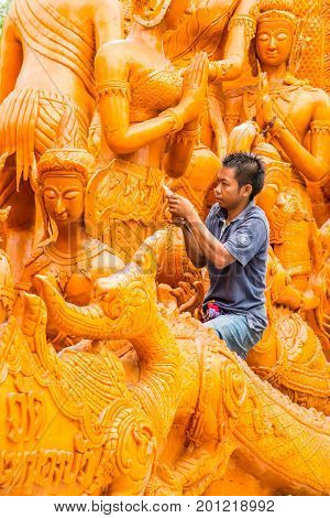 Ubonratchathani Thailand-April 30 2016: Artist man carving candle for marching in candle festival in Ubonratchathani Thailand