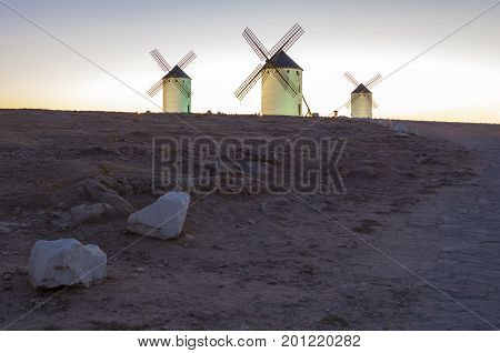 Illuminated traditional windmills at rising Campo de Criptana Spain