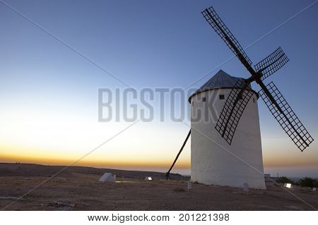 Illuminaed traditional windmill at rising Campo de Criptana Spain