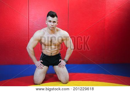 The man in the red shirt is at the gym horizontal