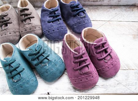 Little girlie baby shoes on a wood