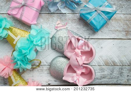 Little girlie baby shoes on a wood
