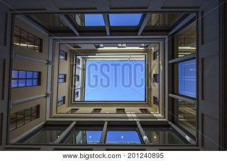 Bottom view of a building with blue sky on the background