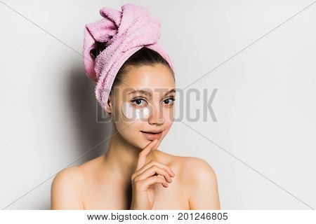 Woman with mask under eye on white