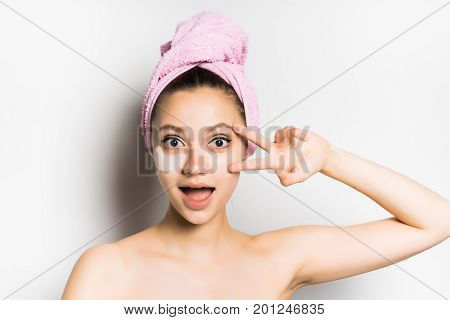 Woman with mask under eye on white