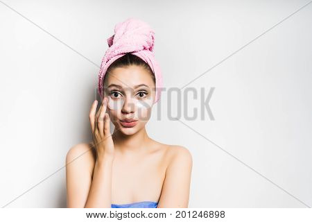 Woman with mask under eye on white