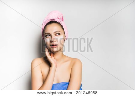 Woman with mask under eye on white