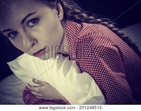 Sad Depressed Girl In Bed Gripping Pillow