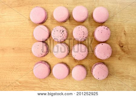 cooking, confectionery and baking concept - macarons on table