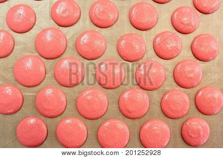 cooking food and confectionery concept - macaron batter or meringue cream on baking paper at pastry shop
