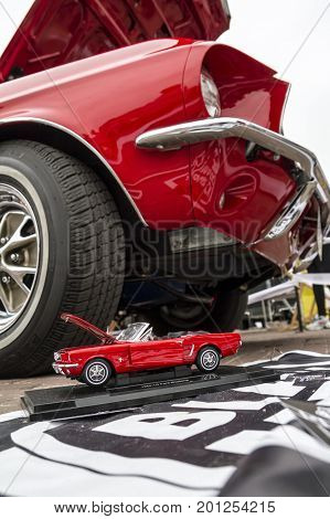 ZAMOSC POLAND - August 13 2017: Classic retro Ford Mustang GT with miniature version.Car exterior details. Headlight of a retro car.