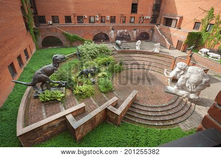 MOSCOW RUSSIA - AUGUST 20 2017: Statues of dinosaurs and a statue of mammoth at Paleontological Museum. The museum is named after Yuri Orlov (1893-1966).