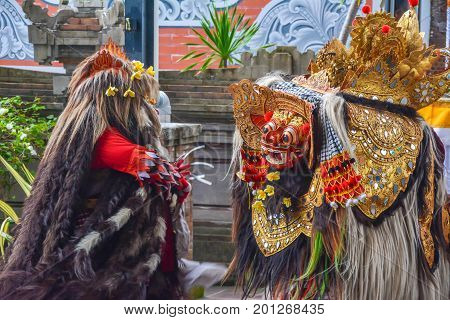 Bali, Indonesia - August 24, 2017: Balinese locals performing Barong, a mythical lion-like creature at a traditional ceremony in Bali.