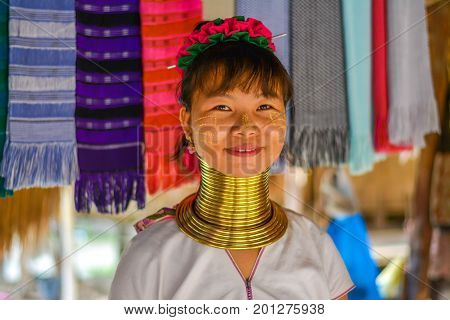 CHIANG MAI, THAILAND - July 10, 2017: Karen hill-tribe (Long Neck) woman weaving fabrics for a living at her house.