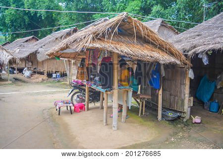 CHIANG MAI, THAILAND - July 10, 2017: Karen hill-tribe (Long Neck) woman weaving fabrics for a living at her house.