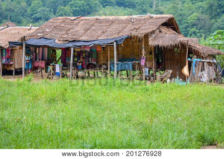 CHIANG MAI, THAILAND - July 10, 2017: Karen hill-tribe (Long Neck) woman weaving fabrics for a living at her house.