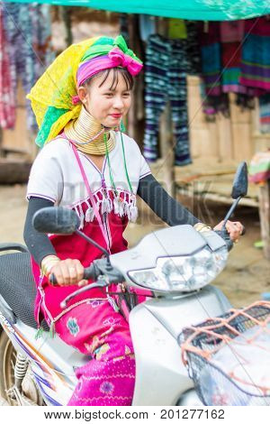 CHIANG MAI, THAILAND - July 10, 2017: Karen hill-tribe (Long Neck) woman weaving fabrics for a living at her house.