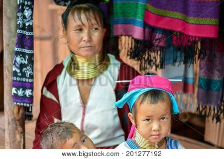 CHIANG MAI, THAILAND - July 10, 2017: Karen hill-tribe (Long Neck) woman weaving fabrics for a living at her house.